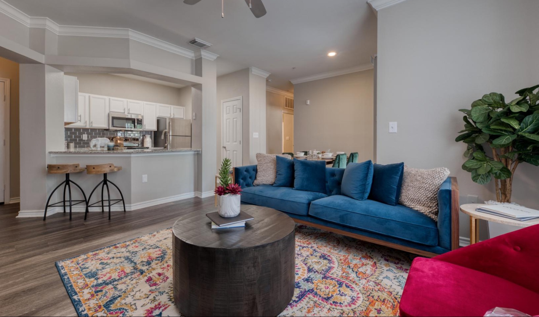 a living room with a blue couch and a table